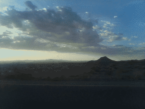 Sunset in western Arizona bathes the clouds and mountains in mysterious light