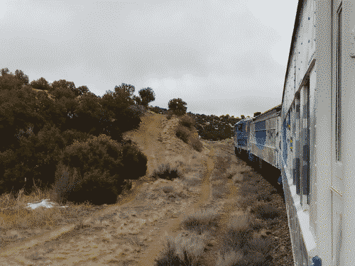 The Christmas Train (Sky Railway) curving ahead on the tracks, shot from the flatbed car toward the back of the train