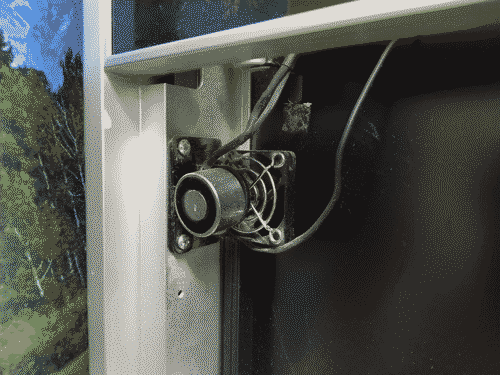 Very strange computer fan mounted to a very strange partially open-faced medical computing kiosk assembly