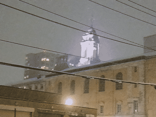 In downtown Portland, Maine, looking over a stout brownstone toward a classic gregorian tower that