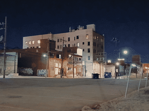 Industrial buildings line an alley in the night of Oklahoma City